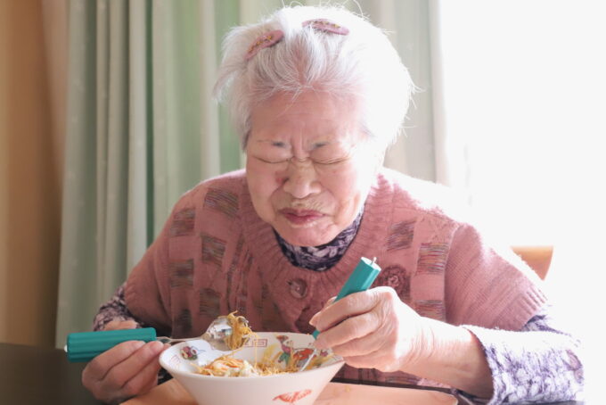 皿うどんを食べて笑顔の祖母