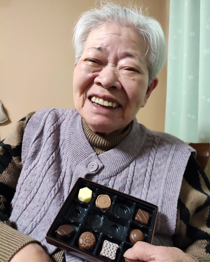 バレンタインデーにプレゼントしたチョコレートの箱を持って笑顔の祖母（おばあ）