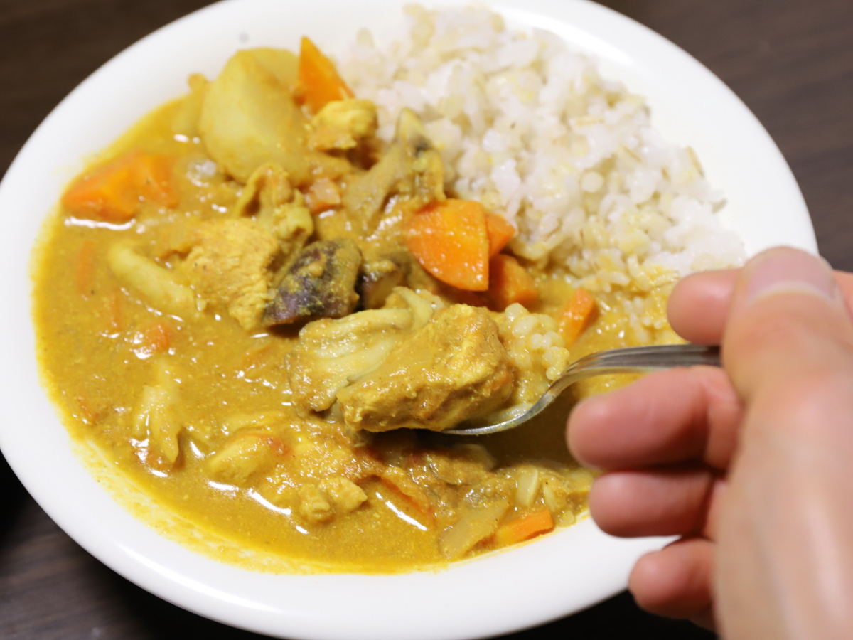 バターチキンカレーをスプーンですくって食べようとしているところ